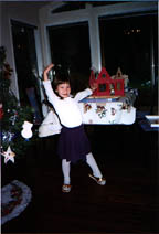 Fiona showing the dollhouse Santa gave her. So far half-finished....